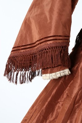 Lot 212 - A brown taffeta day dress circa 1870, the...