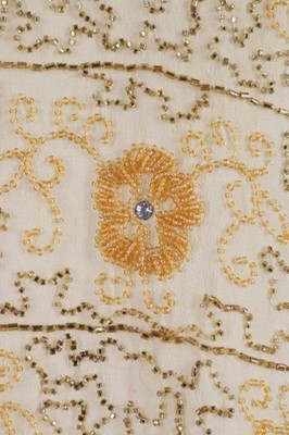 Lot 216 - A beaded yellow muslin flapper dress with...