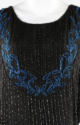 Lot 237 - A beaded black crepe de chine flapper dress,...