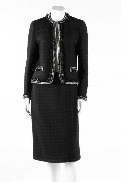 Lot 240 - A Chanel black tweed suit, 1990s, labelled,...