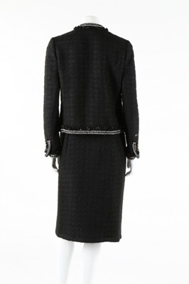 Lot 240 - A Chanel black tweed suit, 1990s, labelled,...