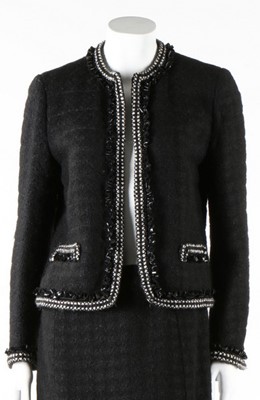 Lot 240 - A Chanel black tweed suit, 1990s, labelled,...