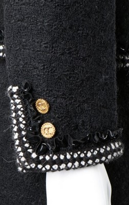 Lot 240 - A Chanel black tweed suit, 1990s, labelled,...