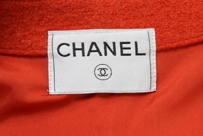 Lot 240 - A Chanel black tweed suit, 1990s, labelled,...