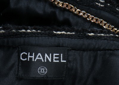Lot 240 - A Chanel black tweed suit, 1990s, labelled,...