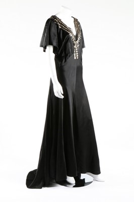 Lot 271 - A black satin bias-cut evening gown with...