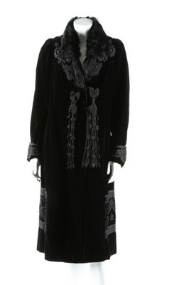 Lot 298 - A black velvet coat with frogging, circa 1910,...