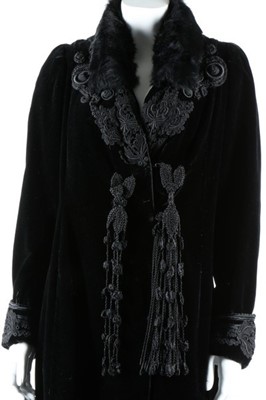 Lot 298 - A black velvet coat with frogging, circa 1910,...