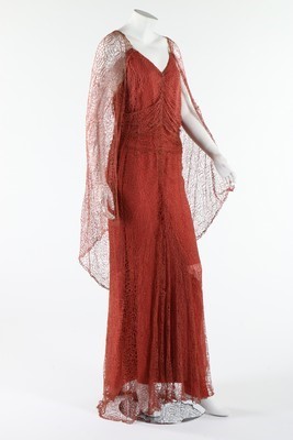 Lot 306 - A coral pink spider-web lace and chiffon...