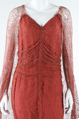 Lot 306 - A coral pink spider-web lace and chiffon...