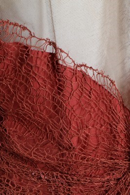 Lot 306 - A coral pink spider-web lace and chiffon...