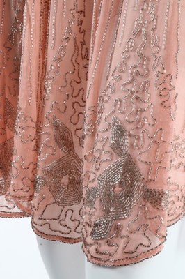 Lot 12 - A beaded pink muslin flapper dress, circa 1928,...