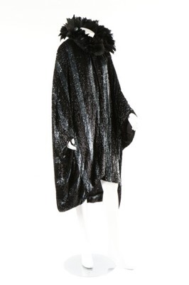 Lot 15 - A dramatic sequined bat-wing opera cape, 1920s,...