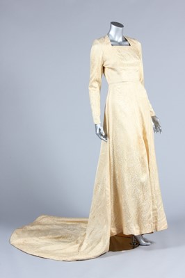 Lot 89 - A brocaded satin bridal gown, 1950, with long...