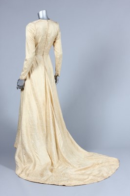 Lot 89 - A brocaded satin bridal gown, 1950, with long...