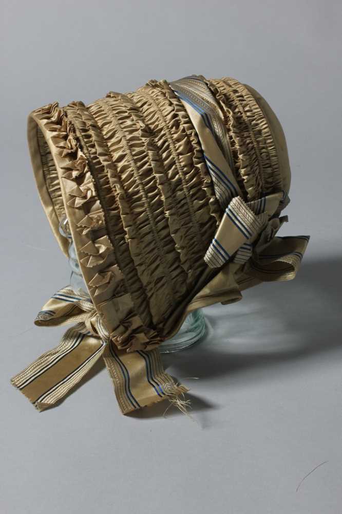 Lot 99 - A gold satin lady's bonnet circa 1840-50, with...