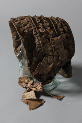 Lot 100 - A brown taffeta bonnet, circa 1850, with...