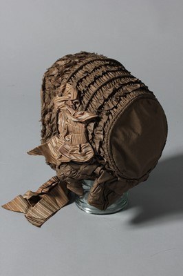 Lot 100 - A brown taffeta bonnet, circa 1850, with...