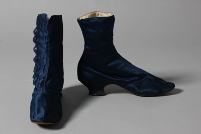 Lot 101 - A pair of dark-blue satin ankle boots, circa...