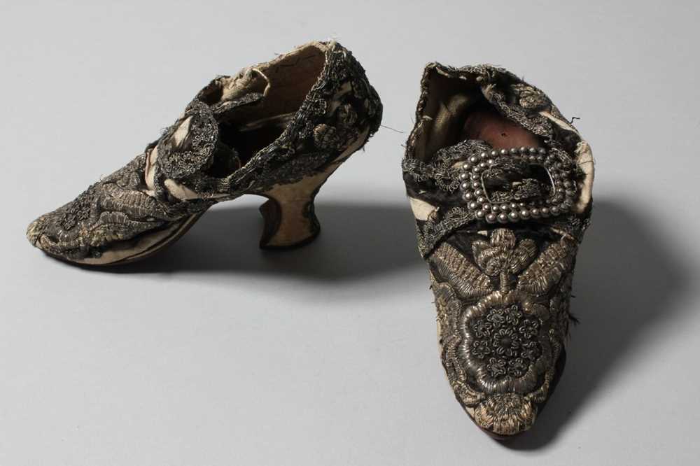 Lot 105 - A pair of lavishly embroidered black satin...