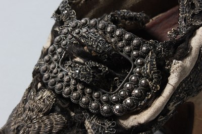 Lot 105 - A pair of lavishly embroidered black satin...