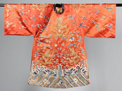 Lot 259 - An embroidered orange satin dragon robe,...