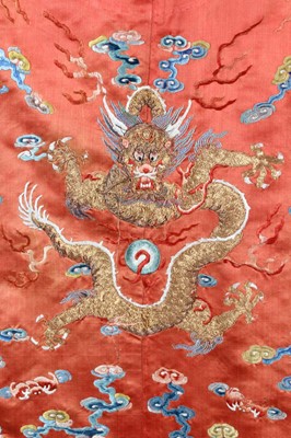 Lot 259 - An embroidered orange satin dragon robe,...