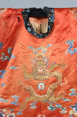 Lot 259 - An embroidered orange satin dragon robe,...