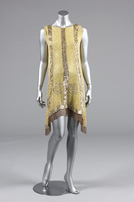 Lot 240 - A beaded primrose-yellow muslin flapper dress,...