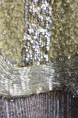 Lot 240 - A beaded primrose-yellow muslin flapper dress,...