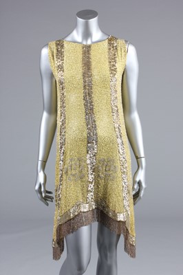 Lot 240 - A beaded primrose-yellow muslin flapper dress,...
