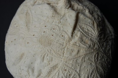 Lot 426 - A quilted and drawn thread-work lady's cap,...