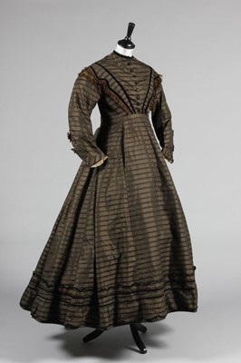 Lot 128 - A striped brown silk day dress, circa 1865,...