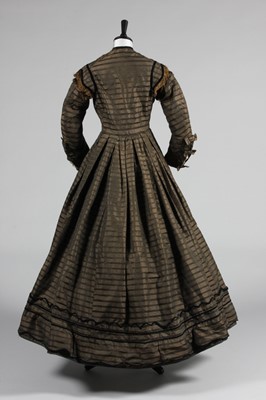Lot 128 - A striped brown silk day dress, circa 1865,...