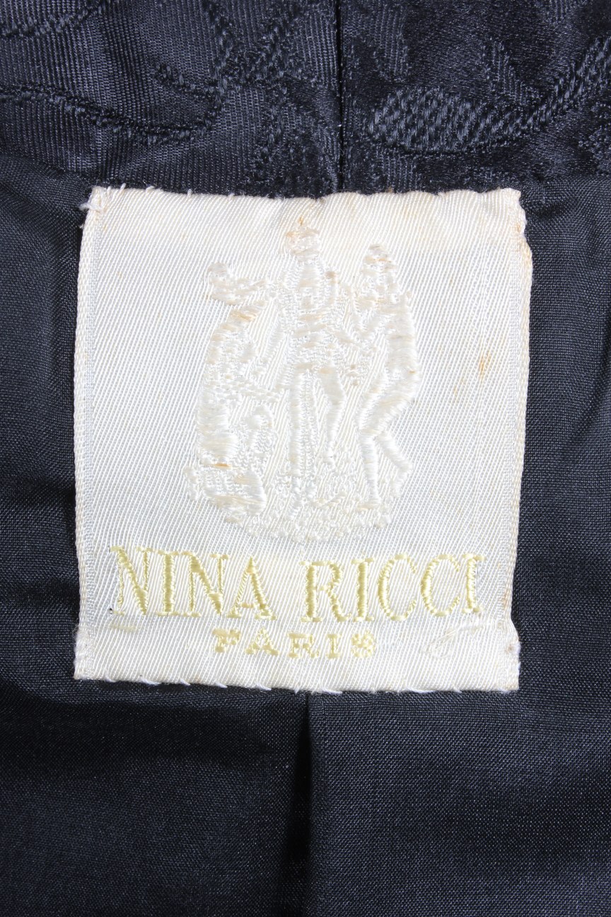 Lot 137 - A Nina Ricci couture black brocatelle dinner