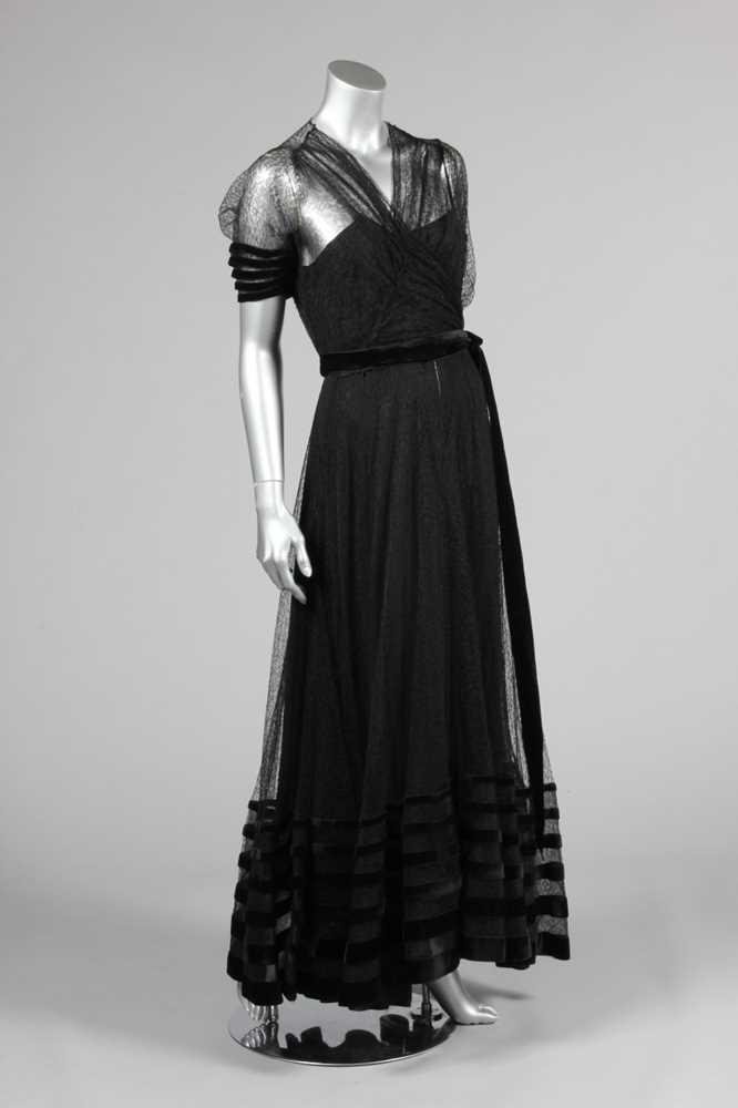Lot 139 - A couture black lace and velvet edged evening...