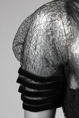 Lot 139 - A couture black lace and velvet edged evening...