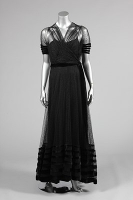 Lot 139 - A couture black lace and velvet edged evening...