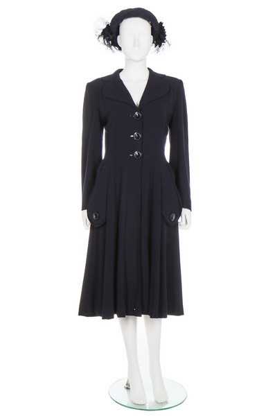 Lot 146 - A Norman Hartnell couture navy wool coat, 1948,...