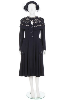 Lot 146 - A Norman Hartnell couture navy wool coat, 1948,...