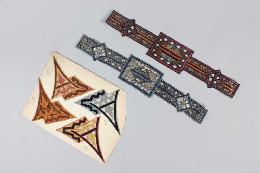 Lot 211 - A large group of embroidered motifs, hat bands,...