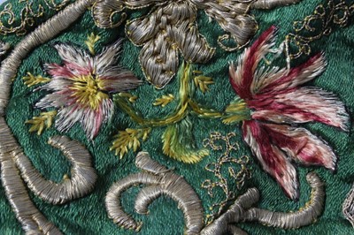 Lot 150 - An embroidered green satin baby cap, probably...