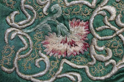 Lot 150 - An embroidered green satin baby cap, probably...
