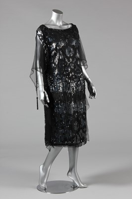 Lot 11 - A sequinned black tulle tabard dress, early...
