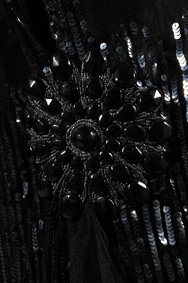 Lot 11 - A sequinned black tulle tabard dress, early...