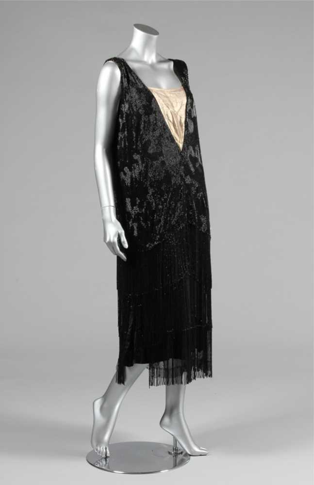 Click for high resolution Lot 15 - A black beaded flapper dress, mid 1920s, the...
