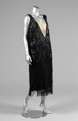 Lot 15 - A black beaded flapper dress, mid 1920s, the...
