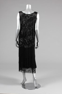 Lot 15 - A black beaded flapper dress, mid 1920s, the...