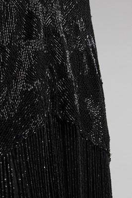 Lot 15 - A black beaded flapper dress, mid 1920s, the...