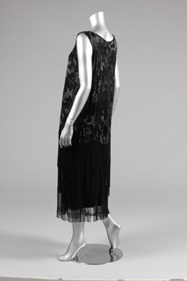 Lot 15 - A black beaded flapper dress, mid 1920s, the...